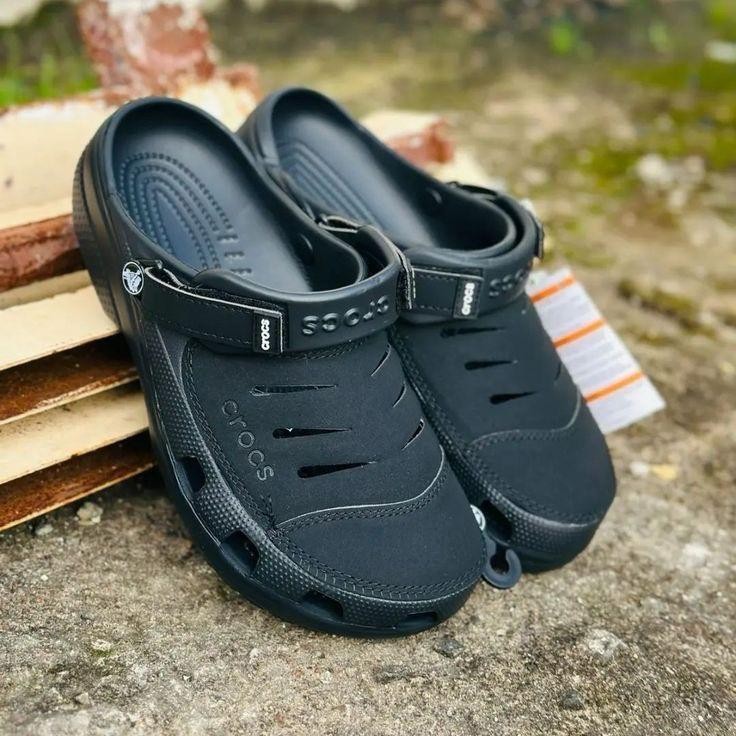 A pair of Crocs Classic Clogs in a greyish-blue color.